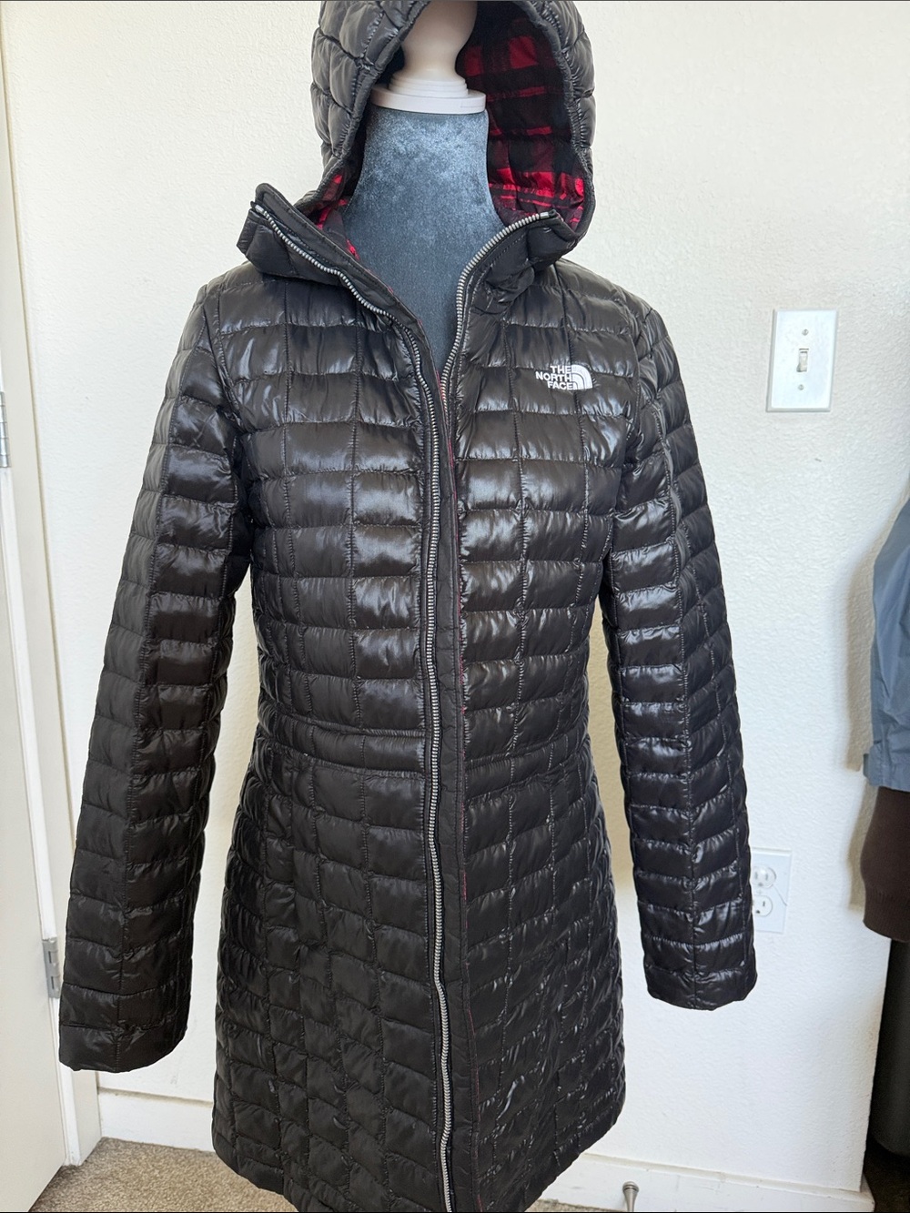 The North Face Women’s Black Quilted Hooded Puffer Coat with Red Plaid Lining